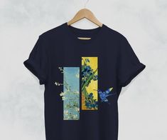 an unisex t - shirt with blue flowers and a bird on the front