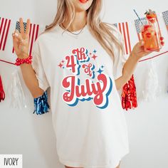 a woman holding a jar of liquid in front of some american flags and streamers