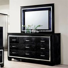 a black dresser and mirror in a room