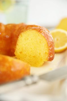 a lemon bundt cake on a plate with a knife and fork