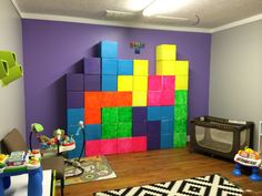 a child's play room with colorful blocks on the wall