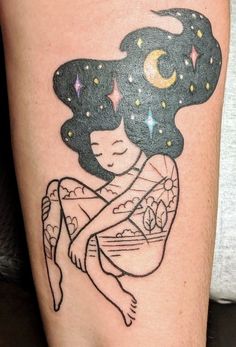 a woman's arm with a tattoo on it that has stars and a moon above her head