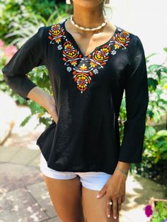 100% Cambric Black cotton top with Orange, Yellow, & Gray Embroidery.  Use As: Fashion top, Beach Cover up, Cotton Kurti, Cotton Tunic Features: A-line. Soft & breathable. Long sleeves. V-neck. Bohemian Embroidered Blouse; Retro Indian Ethnic Hippie Chic Top Care: Cold water machine wash; delicate cycle with embroidery side turned inside out. Hand wash is recommended. Should not be washed with bleach or detergents that contain bleach. Wash with like colors. Tumble dry on low heat or line dry. Ir V-neck Top With Geometric Embroidery For Fall, Bohemian V-neck Top With Resham Embroidery, Traditional Embroidered V-neck Peasant Top, Casual Fitted Tops With Resham Embroidery, Embroidered Top For Vacation In Fall, Embroidered V-neck Festival Top, Fall Vacation Embroidered Blouse, Casual Long Sleeve Tops With Resham Embroidery, Black Cotton Top With Chikankari Embroidery