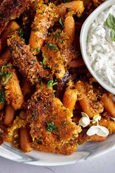 a white plate topped with chicken wings and ranch dip