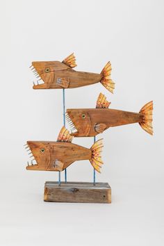 three wooden fish sculptures sitting on top of each other