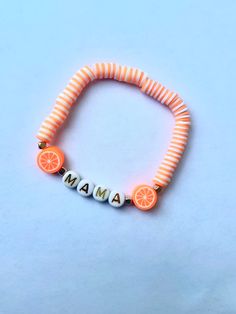 "This charming stretch bracelet showcases a collection of beautiful orange beads, creating a warm and eye-catching color palette. The orange beads exude a lively and energetic vibe, adding a pop of color to your wrist. Intermingled with the orange beads are special accent beads that spell out the word \"MAMA.\" These beads are carefully crafted with a combination of orange and white colors, creating a delightful contrast against the backdrop of the vibrant orange beads. The letters are spelled out in a playful and stylish font, adding a personal touch to the bracelet. The bracelet is designed with a stretchy elastic cord, allowing for easy and comfortable wearing. The elastic nature of the bracelet ensures a flexible fit that can accommodate various wrist sizes." Fruit Bracelet, Mama Bracelet, Beaded Braclets, Preppy Bracelets, Stylish Fonts, Clay Bead, White Colors, Vibrant Orange, Eye Catching Colors