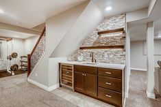 a bathroom with a sink under a stair case