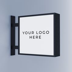 a black and white sign hanging on the wall next to a gray wall that says your logo here