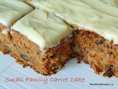 a carrot cake with white frosting on top is cut in half and ready to be eaten