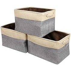 three storage bins with handles on each side and one in the middle, two are grey