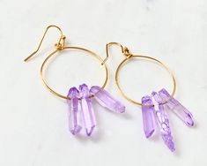 Raw purple quartz crystal points in gold or silver hoop earrings with French hooks. Perfect little boho look. Light weight and easy to wear. Add these to your boho outfits and make a 💜Healing clear quartz Crystal property has been know for centuries to restore balance in the body. -Options- 30mm as shown 21 gauge hoops Total drop Length: 2.3 inches 14k Gold filled hoops Sterling silver hoops Gold plated hoops Silver plated hoops All comes with hooks Simple, Dainty, Delicate, yet so Elegant and Trendy Hoop Jewelry For Jewelry Making, Purple Small Hoop Jewelry For Gifts, Purple Hoop Jewelry For Gift, Trendy Purple Small Hoop Jewelry, Minimalist Nickel-free Purple Jewelry, Trendy Small Hoop Purple Jewelry, Trendy Purple Hoop Jewelry, Purple Bohemian Hoop Earrings For Gift, Affordable Metal Hoop Crystal Earrings