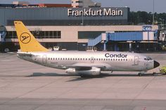 an airplane sitting on the tarmac at an air port run way with buildings in the background