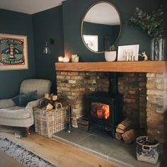 a living room filled with furniture and a fire place next to a mirror on the wall