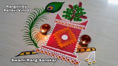 rangoli diya with peacock decoration on the floor