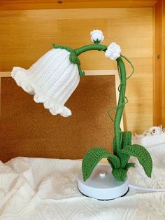 a crocheted plant with white flowers on it