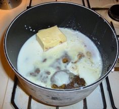 a pan filled with food on top of a stove next to a burner oven