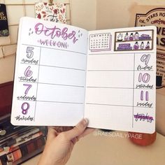 someone is holding up a planner with the date and time for each month on it