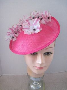 *  This  11" diameter Hot Pink  Sinamay hat has a turned up brim and has been trimmed with delicate pink and white flowers. *  To add a bit more drama a patch of flowers fill in the center. *  The metal head band secures the design and it is light weight and comfortable to wear. *  Designed for any Derby occasion, Wedding Event, Birthday Celebration, Garden or Tea Party, Baby or Wedding Shower, Ladies Gathering or just for fun. Spring Beach Fascinator, Fitted, Spring Beach Fascinator, Pink Sun Hat For Spring Weddings, Pink Cloche Hat With Curved Brim, Fitted Pink Brimmed Cloche Hat, Fitted Short Brim Pink Hat, Fitted Pink Hat With Short Brim, Pink Fitted Hat With Short Brim, Pink Adjustable Cloche Hat For Spring