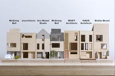 a group of wooden model houses sitting on top of each other