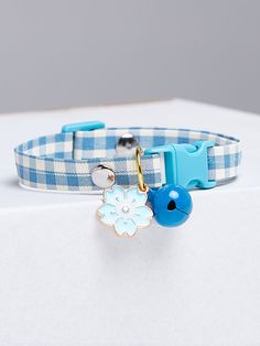 a blue and white dog collar with a snowflake charm