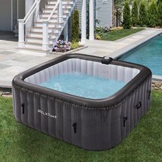 an inflatable hot tub sitting next to a swimming pool