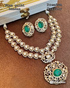 This stunning jewellery set is inspired by the renowned designer Sabyasachi. The set includes a beautiful necklace featuring an uncut polki kundan stone and a doublet stone. The necklace is made of brass and is perfect for women who love to accessorise with ethnic jewellery. The set is a great addition to any jewellery collection and is perfect for special occasions. The stone and brass material make this set a unique and durable piece. Get ready to turn heads with this exquisite jewellery set. Luxury Kundan Necklace With Stone Work For Gift, Diamond Chandbali Kundan Necklace For Reception, Diamond Kundan Necklace With Meenakari For Receptions, Luxury Kundan Bridal Necklace With Intricate Design, Luxury Kundan Necklace With Stone Work For Festive Season, Designer Gold Necklace With Intricate Design, Gold Necklace With Intricate Design For Designer Wear, Heavy Bollywood Kundan Necklace With American Diamonds, Festive Diamond Kundan Chandbali Necklace