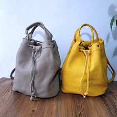 The charming Convertible Leather Bucket Bag is the perfect combination of elegance and practicality. Crafted from high-quality leather, this model offers a convenient conversion from a classic bag to a comfortable backpack. Its unique design allows for easy shape-shifting, providing style and functionality for any occasion. The yellow pouch and beige pouch bag is from soft genuine leather. Backpacks are crossbody and leather totes for women's. Beige backpack is work backpack and messenger purse. Versatile Leather Satchel Bucket Bag, Trendy Leather Bucket Bag For Travel, Trendy Leather Travel Bucket Bag, Leather Lining Bucket Bag, Luxury Bucket Bag Backpack For Daily Use, Versatile Beige Leather Bucket Bag, Daily Use Leather Bucket Bag With Soft Leather, Luxury Bucket Bag With Mobile Phone Bag For Everyday, Large Capacity Leather Pouch Bucket Bag