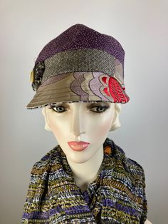 This pretty purple, beige, red and black baseball style multi fabric newsboy cap is a standout! It is made with lovely sample fabrics that would have been destroyed but instead was made into a functional and pretty accessory. It is topped with a rosette and vintage mother of pearl button. The hat is fully lined with a pretty cotton fabric and an inner grosgrain ribbon helps the hat keep its shape and keep it free from makeup. This baseball/newsboy shape is deeper than a traditional baseball hat and sits lower on the head - looks best with your ears tucked under. Wear the brim down in the traditional manner or flip it back for an additional look. A great hat for travel as well. In stock and ready to ship. ++++++++++++++++++++++++++FIT AND SIZE: Comfortably fits a 21 1/2 to 22 1/2 inch head Newsboy Hat, Pretty Purple, Hat Baseball, News Boy Hat, Winter Hats For Women, Newsboy Cap, Casual Hat, Beautiful Hats, Mother Of Pearl Buttons