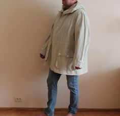 "Vintage Jacket Canvas Parka Grey Windbreaker Gray Unisex Jacket Bomber Jacket Button Up Lightweight Parka Oversized Hooded Plus Size Extra Large Label size: C 54 Shown on model XL Measurements (lying flat): Length: 37.5\"/ 95 cm Shoulders: 22.5\"/ 57 cm Sleeve: 28\"/ 71 cm Pit to pit: 32\"/ 81 cm Condition: great Vintage Condition Please check measurements to insure a proper fit. Remember to allow yourself some extra room for movement. You can compare these with something from your closet that Hooded Khaki Outerwear With Buttons, Khaki Hooded Outerwear With Button Closure, Oversized Button-up Outerwear For Outdoor, Oversized Beige Outerwear With Adjustable Hood, Beige Hooded Outerwear With Buttons, Utility Hooded Outerwear With Buttons, Hooded Outerwear With Button Closure For Outdoor, Casual Hooded Outerwear With Button Cuffs, Khaki Outdoor Outerwear With Buttons