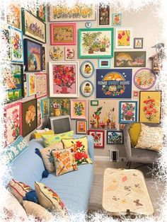 a living room filled with lots of colorful pictures on the wall and couches covered in pillows