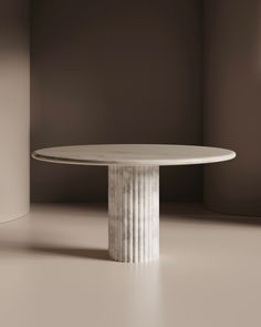 a white table sitting in the middle of a room