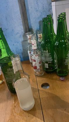 several empty beer bottles on a wooden table