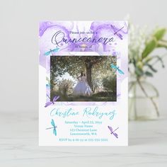 a purple and blue wedding card with a photo on the front, surrounded by dragonflies