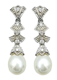 This exquisite pair of pearl and diamond dangle earrings are meticulously crafted in 14 karat white gold. These elegant earrings each feature a single lustrous pearl at the bottom, providing a timeless focal point that exudes sophistication. Adorning the earrings are delicate white gold bow designs, intricately embellished with sparkling diamonds that add a touch of brilliance and charm. The combination of the classic pearl, radiant diamonds, and the refined white gold setting makes these earrings perfect for any special occasion, adding a touch of elegance to any ensemble. A truly timeless addition to any fine jewelry collection. This piece is in very good estate condition and has been professionally cleaned and polished. It comes with an appraisal certificate, verifying its authenticity Bow Designs, Diamond Bows, White Gold Set, Diamond Dangle Earrings, Radiant Diamond, Bow Design, Fine Jewelry Collection, Pearl Diamond, Elegant Earrings