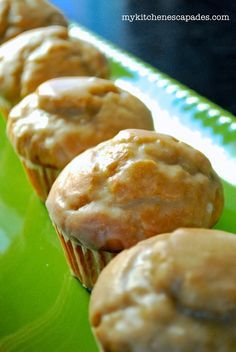 some muffins are sitting on a green plate