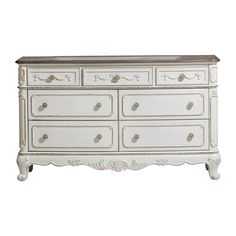 an antique white dresser with drawers