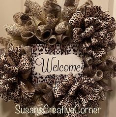 a leopard print wreath with the words welcome on it