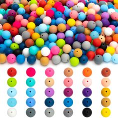 many different colors of plastic beads on a white surface