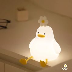 a light that is on the ceiling with a chicken in it's head and legs