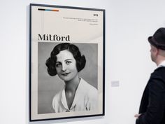 a man looking at a poster on the wall