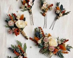 four different types of flower hair pins on a white surface with orange and pink flowers