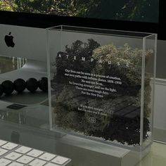 an apple computer sitting on top of a desk next to a keyboard and monitor screen