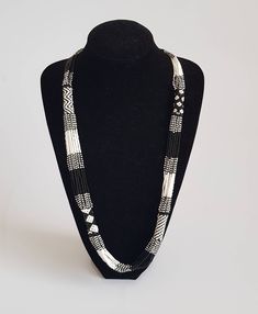 This necklace is 100% handcrafted using black and white fine beads. The necklace makes a perfect gift to loved ones. Dimensions; 32 inches. **Buy multiple items and pay shipping for 1 item only.The rest ships free. Custom orders are welcome. More neckleces here; https://www.etsy.com/shop/TribalTess?ref=seller-platform-mcnav&section_id=21306083 Back to my shop; https://www.etsy.com/shop/TribalTess?ref=seller-platform-mcnav White Long Chain Necklace, White Beaded Chain Long Necklace, White Multi-strand Long Necklace As Gift, White Bohemian Necklace With Black Beads, White Long Necklace With Round Beads For Gift, White Long Necklace With Round Beaded Chain, White Beaded Long Necklace, White Long Beaded Necklace, Handmade White Beads Long Necklace