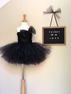 For your little darling who loves fluffy tutus and bows! This dress is handmade to order with 6 layers of tulle, tulle hand-ruched onto the bodice front and back, a corset style closure on the back and a handmade tulle bow on the shoulder! ** Default color for this dress is black but if you would like a custom color please use the form below to inquire about availability. Over 20 colors are available CURRENT PROCESSING TIME: 2 weeks. ** Upon checkout, if you would like a perfect fit please inclu Tulle Tutu Dress With Bow For Dress-up, Whimsical Ruffled Tutu Dress For Pageant, Whimsical Ruffled Tutu Dress For Pageants, Princess Tutu Dress With Ruffles, Tulle Tutu Dress For Pageants, Princess Style Tulle Tutu Dress With Ruffles, Tulle Tutu Dress For Pageant, Whimsical Tulle Dress, Black Tulle Dress With Bow Detail