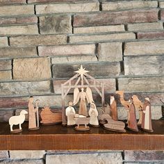 a nativity scene is displayed on a mantle