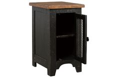 an old black cabinet with a wooden top and door on the bottom, isolated against a white background