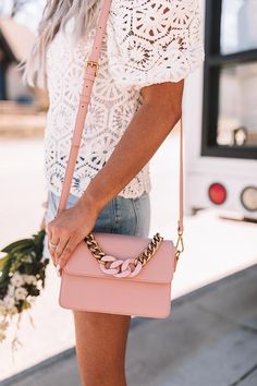 Get date night ready with this chic pink crossbody featuring lightweight faux leather material, a removable and adjustable shoulder strap, a gold large link chain handle with black accent links, and a spacious rectangular pouch with a flap snap button closure and additional inside pockets!