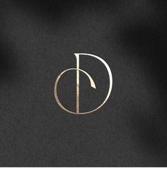 a black and gold logo with the letter d in it's center, on a dark background