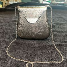 2 inches inches wide 6 inches high 5 1/2 inches at the widest point Strap measures 29 inches long Navy blue velvet lining made in Italy metal bag Silver Satchel Evening Bag, Vintage Clutch Shoulder Bag For Party, Formal Silver Shoulder Bag With Removable Pouch, Formal Shoulder Evening Bag With Chain Strap, Classic Silver Shoulder Bag For Formal Occasions, Classic Silver Shoulder Bag For Formal Events, Retro Rectangular Evening Bag For Formal Occasions, Retro Evening Crossbody Bag, Silver Shoulder Bag With Removable Pouch For Evening