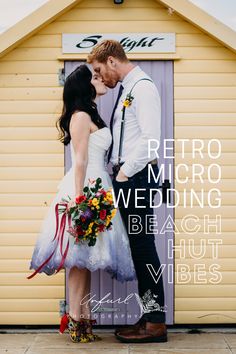 a man and woman standing next to each other in front of a yellow building with the words retro micro wedding beach hut vibes